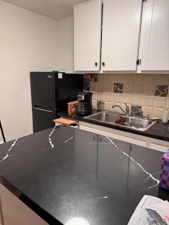 a kitchen with a sink and cabinets