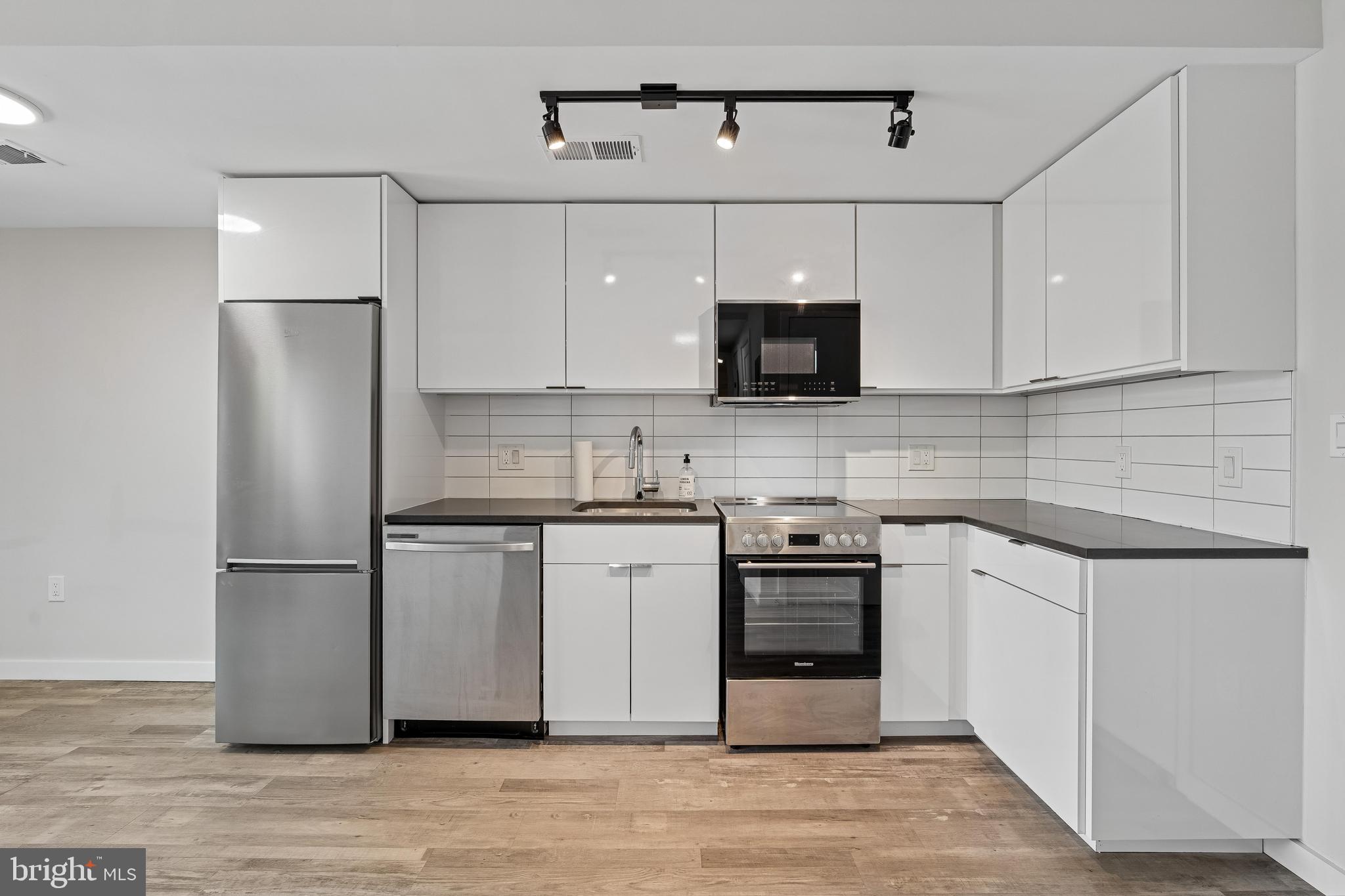 700 Roeder Road, Unit 401 Silver Spring, MD 20910 - Photo 11 of 30 a kitchen with stainless steel appliances a refrigerator stove and microwave