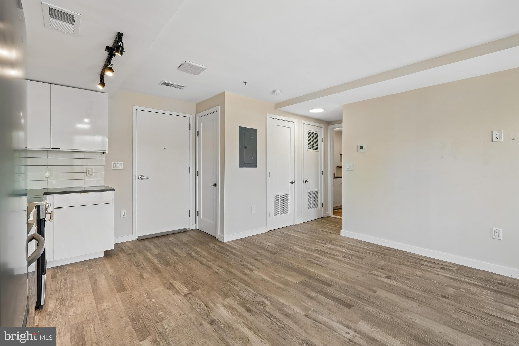 700 Roeder Road, Unit 401 Silver Spring, MD 20910 - Photo 15 of 30 a view of empty room with wooden floor and kitchen