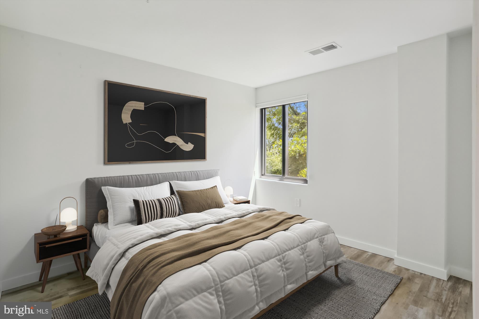 700 Roeder Road, Unit 401 Silver Spring, MD 20910 - Photo 19 of 30 a bedroom with a bed and a painting on the wall