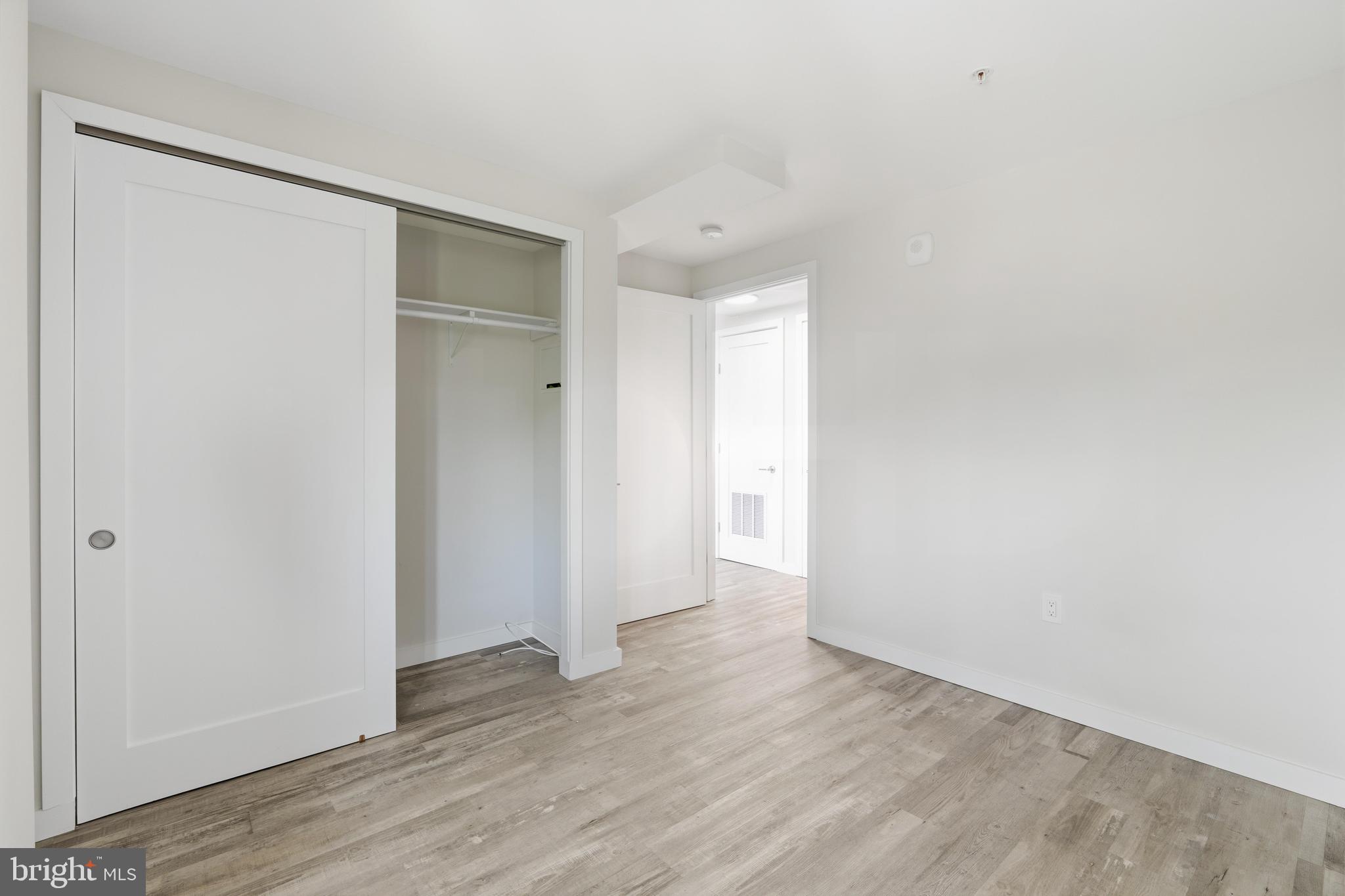 700 Roeder Road, Unit 401 Silver Spring, MD 20910 - Photo 21 of 30 a view of an empty room with wooden floor