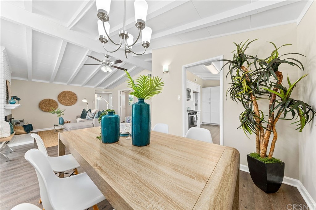 6737 Delco Avenue Winnetka, CA 91306 - Photo 11 of 31 a dining room with chandelier fan and wooden floor