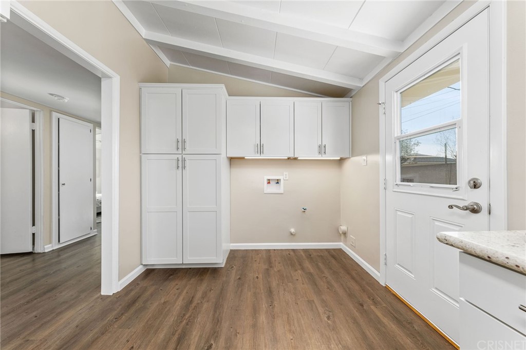 6737 Delco Avenue Winnetka, CA 91306 - Photo 14 of 31 a view of a kitchen with wooden floor and electronic appliances