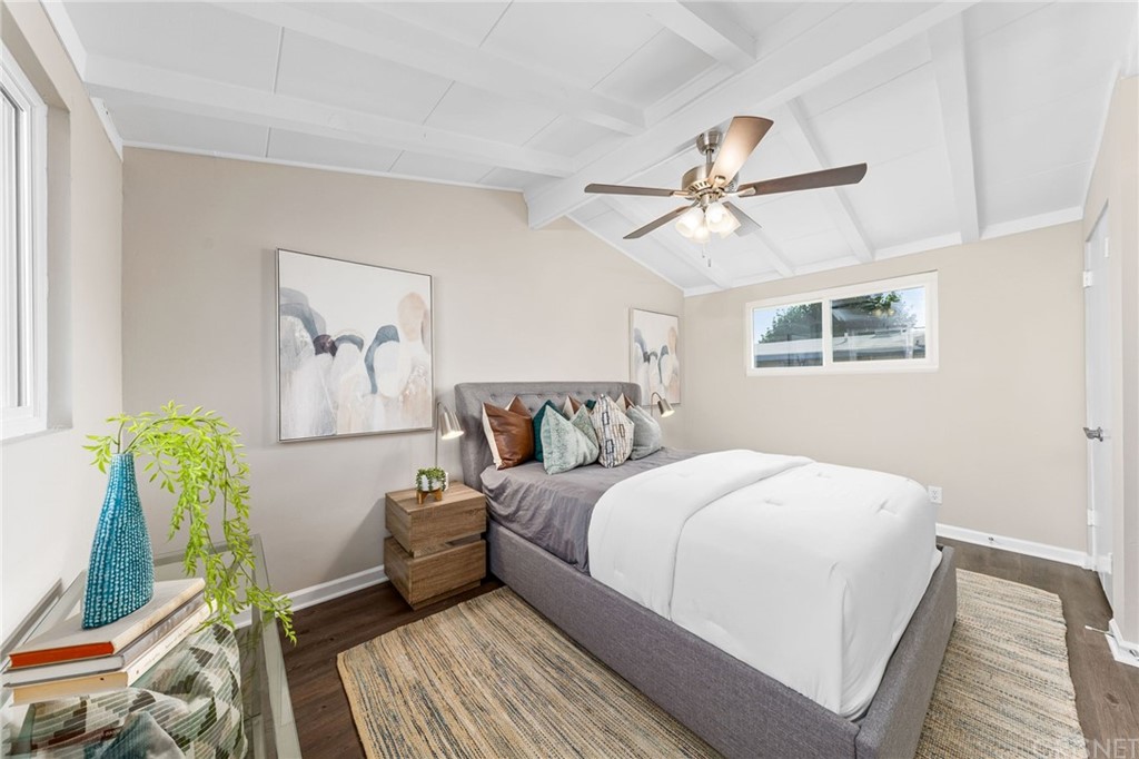 6737 Delco Avenue Winnetka, CA 91306 - Photo 16 of 31 a bedroom with a bed and wooden floor