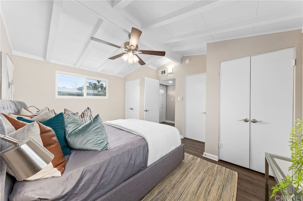 6737 Delco Avenue Winnetka, CA 91306 - Photo 17 of 31 a spacious bedroom with a bed and ceiling fan