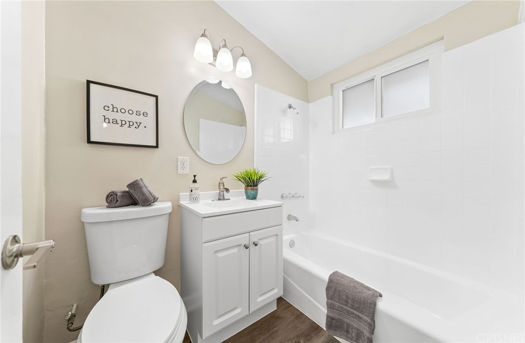 6737 Delco Avenue Winnetka, CA 91306 - Photo 18 of 31 a bathroom with a toilet a sink and a mirror