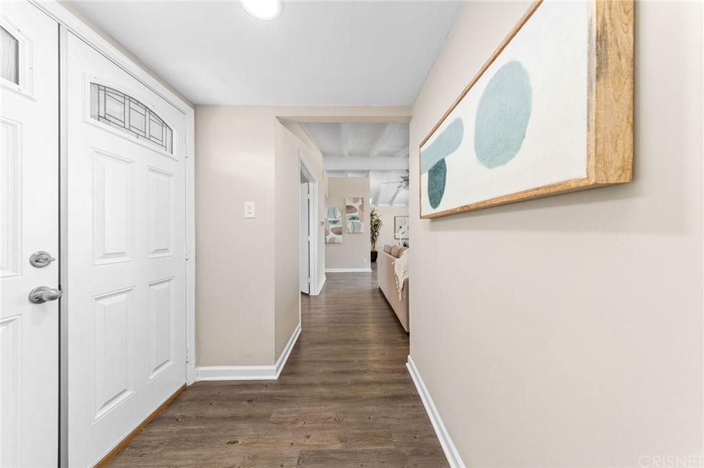 6737 Delco Avenue Winnetka, CA 91306 - Photo 2 of 31 a view of a hallway with wooden floor and entryway