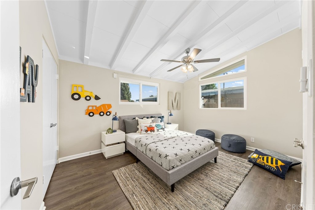 6737 Delco Avenue Winnetka, CA 91306 - Photo 21 of 31 a bedroom with a bed and a couch