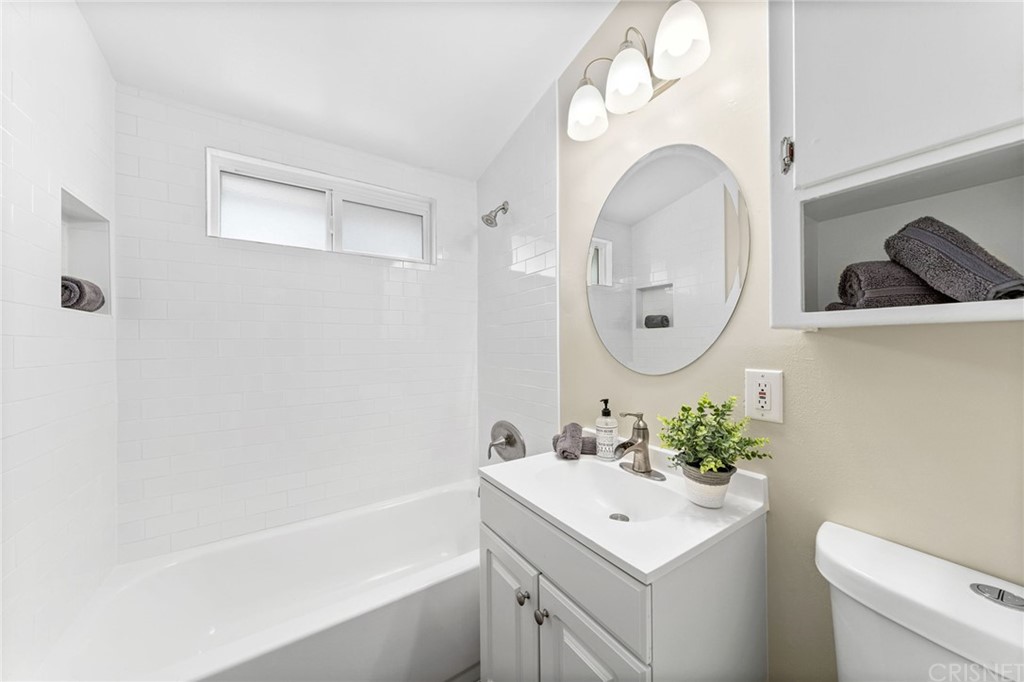 6737 Delco Avenue Winnetka, CA 91306 - Photo 25 of 31 a bathroom with a sink and a mirror