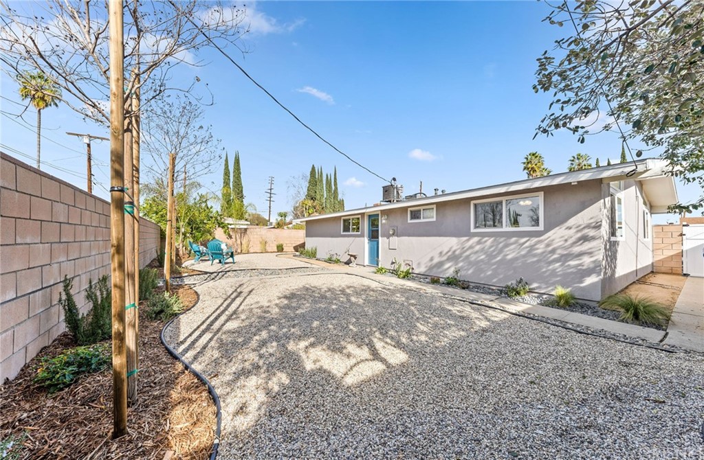 6737 Delco Avenue Winnetka, CA 91306 - Photo 26 of 31 a view of a house with a yard and pathway