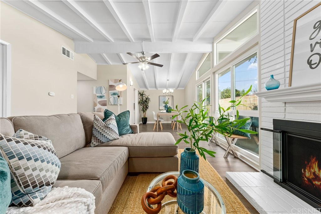 6737 Delco Avenue Winnetka, CA 91306 - Photo 5 of 31 a living room with furniture a fireplace and a potted plant