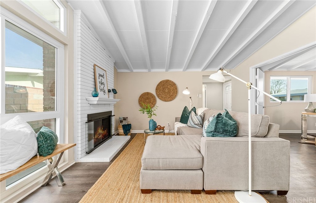 6737 Delco Avenue Winnetka, CA 91306 - Photo 7 of 31 a living room with furniture and a fireplace