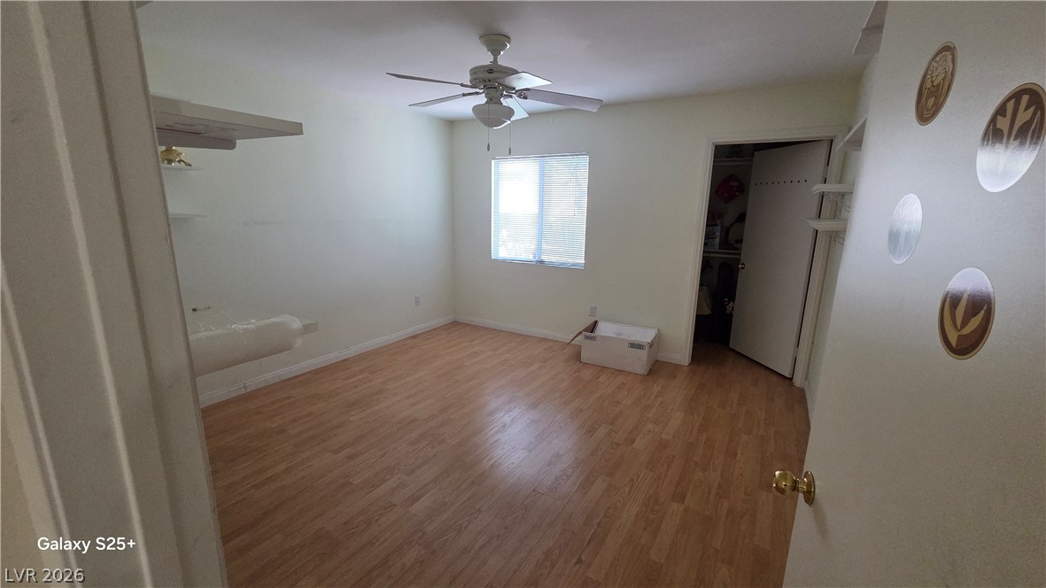 7885 West Flamingo Road, Unit 1008 Las Vegas, NV 89147 - Photo 18 of 29 Well-lit room with wood flooring, ready for personalization.