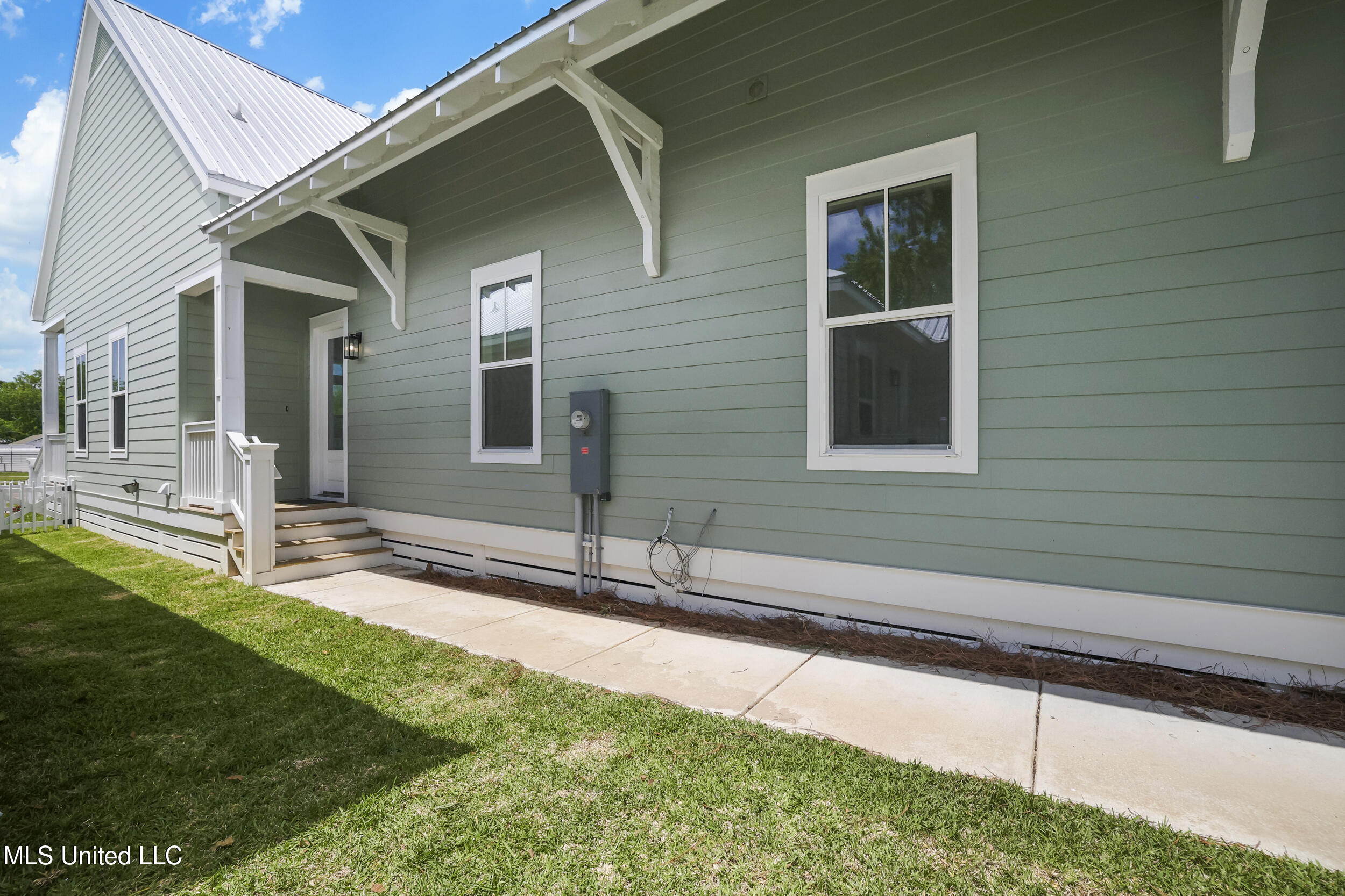 254 Caillavet Street Biloxi, MS 39530 - Photo 29 of 44 OUTSIDE EXIT DOOR AND SIDE YARD
