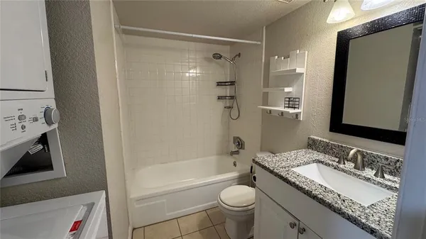 a bathroom with a tub toilet and shower