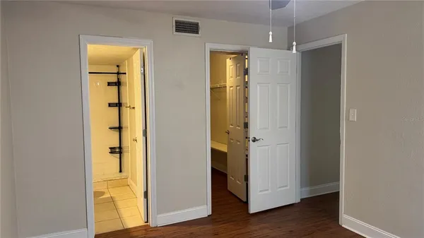 a bathroom with a granite countertop shower and a toilet