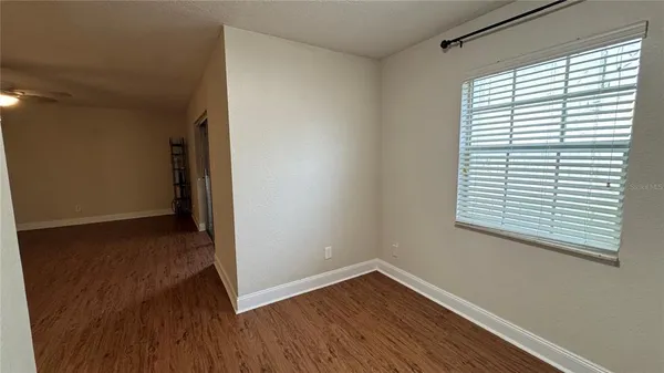 a view of a room with wooden floor and a window