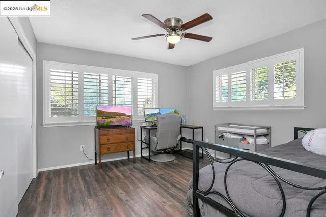 a bedroom with furniture window and wooden floor