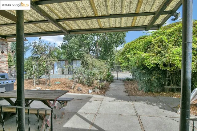 a backyard of a house with fountain table and chairs