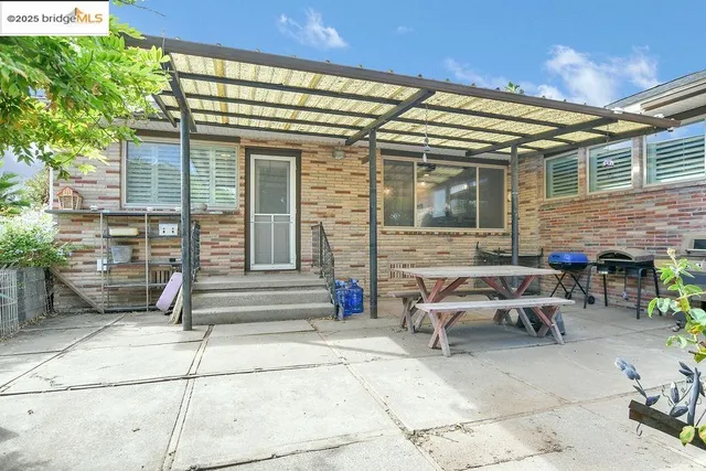 a view of a patio with table and chairs and potted plants