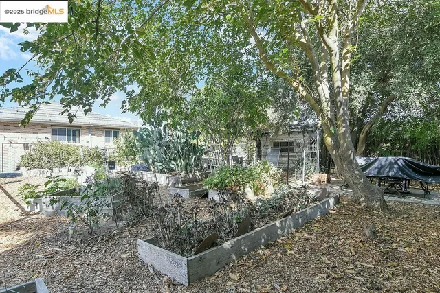 a view of a house with a yard and sitting area