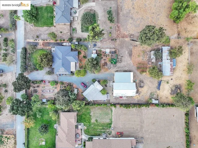 an aerial view of a house with a yard