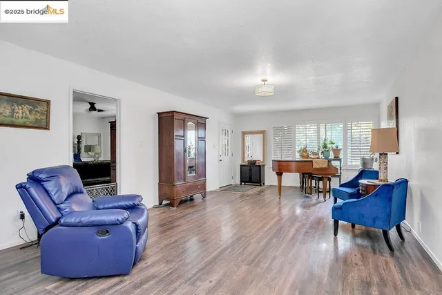 a living room with furniture and wooden floor