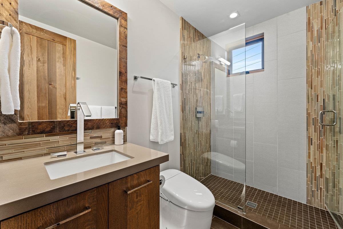 8370 Valhalla Drive Truckee, CA 96161 - Photo 11 of 21 a bathroom with a double vanity sink toilet and shower