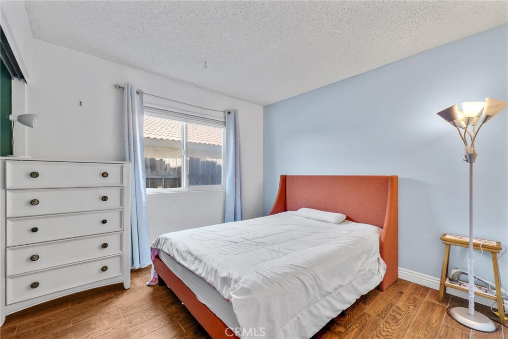 3415 Siskiyou Circle Riverside, CA 92503 - Photo 19 of 41 a bedroom with a bed a lamp and closet