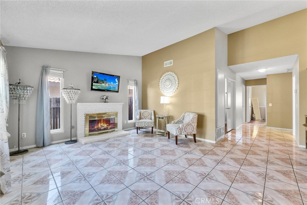 3415 Siskiyou Circle Riverside, CA 92503 - Photo 6 of 41 a living room with furniture a fireplace and a flat screen tv