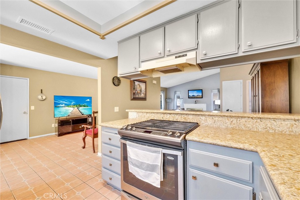 3415 Siskiyou Circle Riverside, CA 92503 - Photo 8 of 41 a kitchen with stainless steel appliances granite countertop a stove and a cabinets