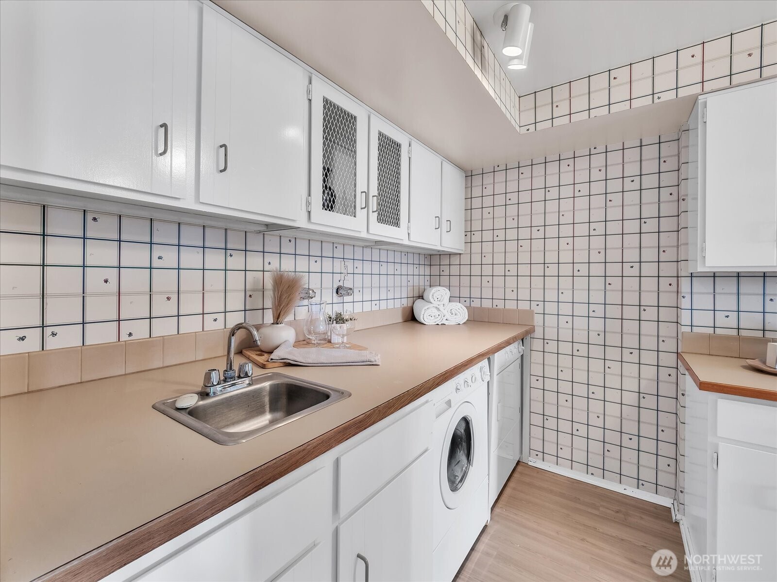 8001 Sand Point Way Northeast, Unit C57 Seattle, WA 98115 - Photo 11 of 23 a bathroom with a sink a vanity and a blue shower
