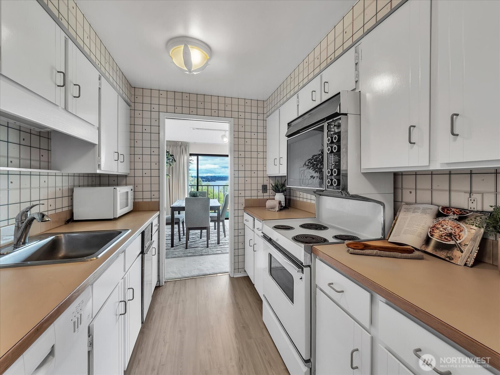 8001 Sand Point Way Northeast, Unit C57 Seattle, WA 98115 - Photo 12 of 23 a kitchen with granite countertop a sink stove and cabinets