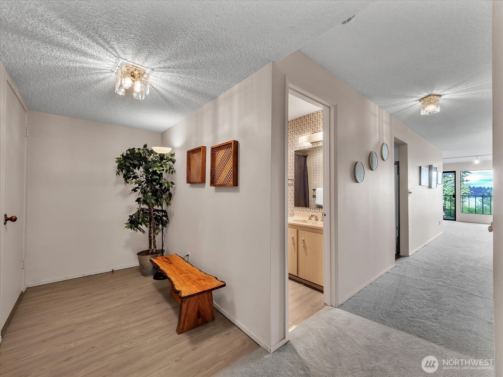 8001 Sand Point Way Northeast, Unit C57 Seattle, WA 98115 - Photo 18 of 23 a room with chandelier fan and wooden floor