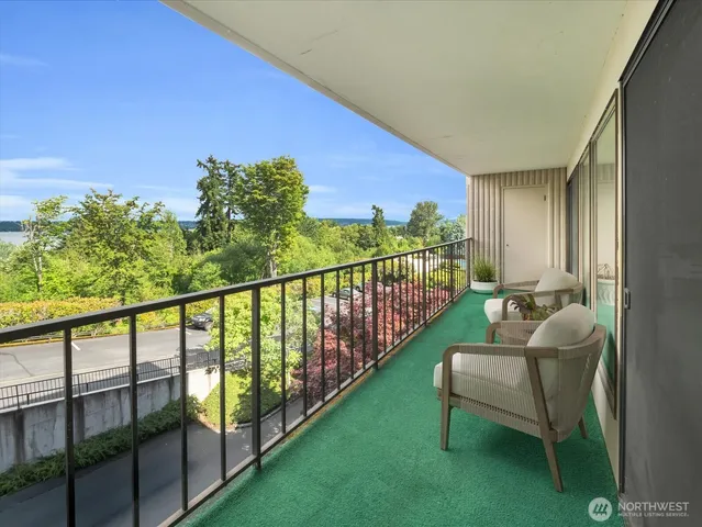 a view of a two chairs in the balcony
