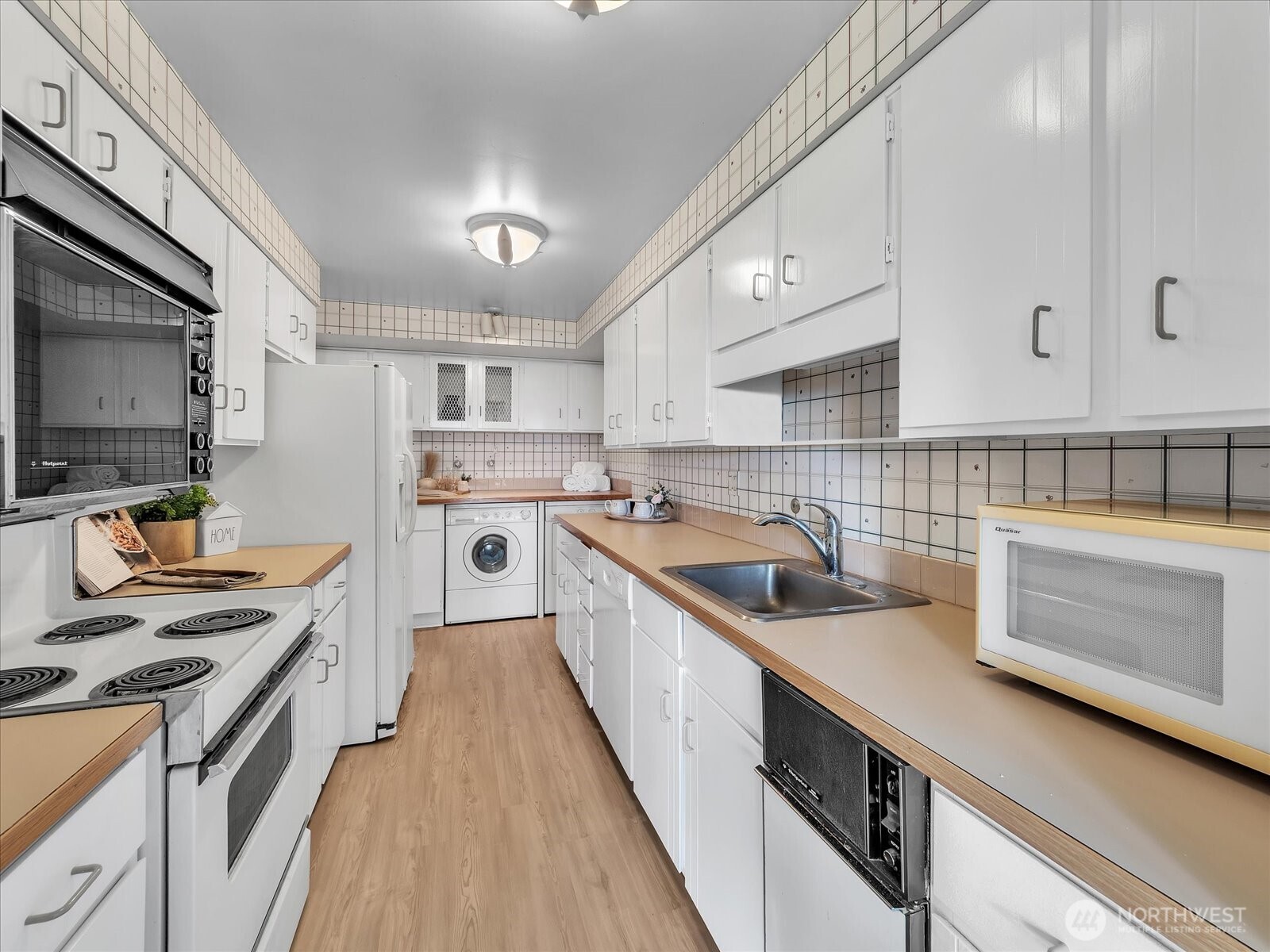 8001 Sand Point Way Northeast, Unit C57 Seattle, WA 98115 - Photo 10 of 23 a kitchen with a sink stove top oven and refrigerator