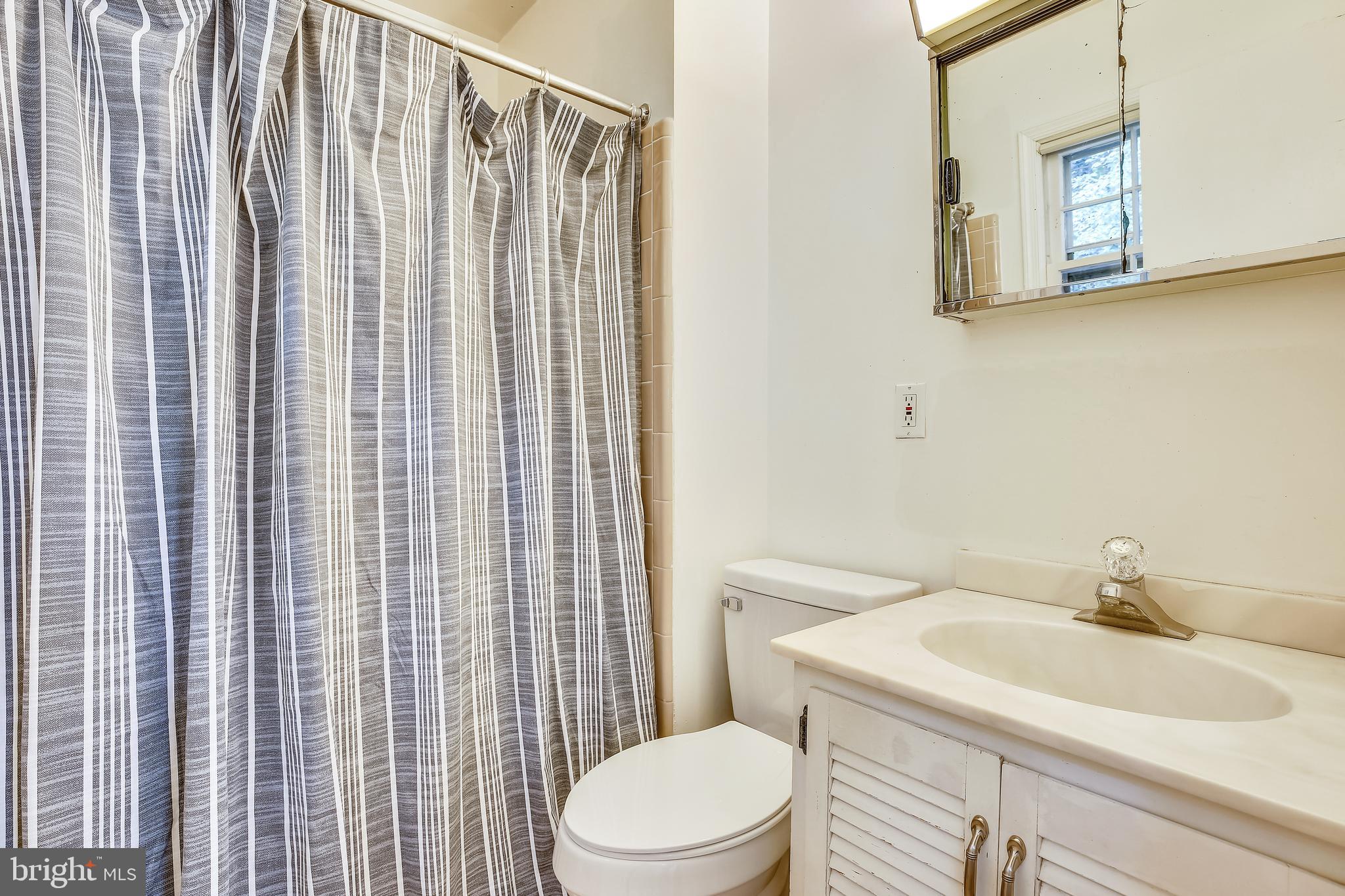 9505 Emory Grove Road Gaithersburg, MD 20877 - Photo 33 of 75 a bathroom with a sink toilet and shower