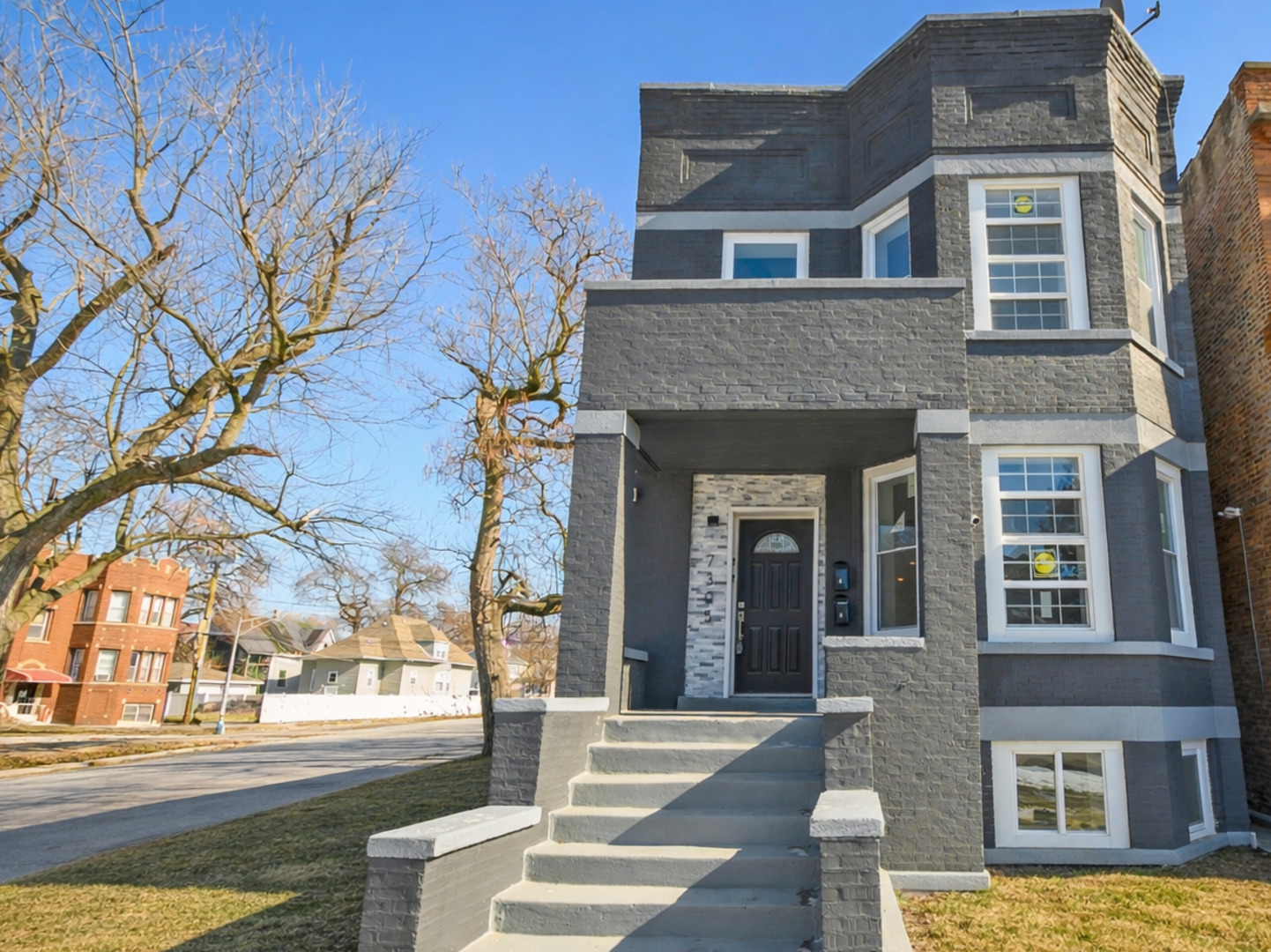 7305 South Sangamon Street Chicago, IL 60621 - Photo 1 of 29 a front view of a house with a garden