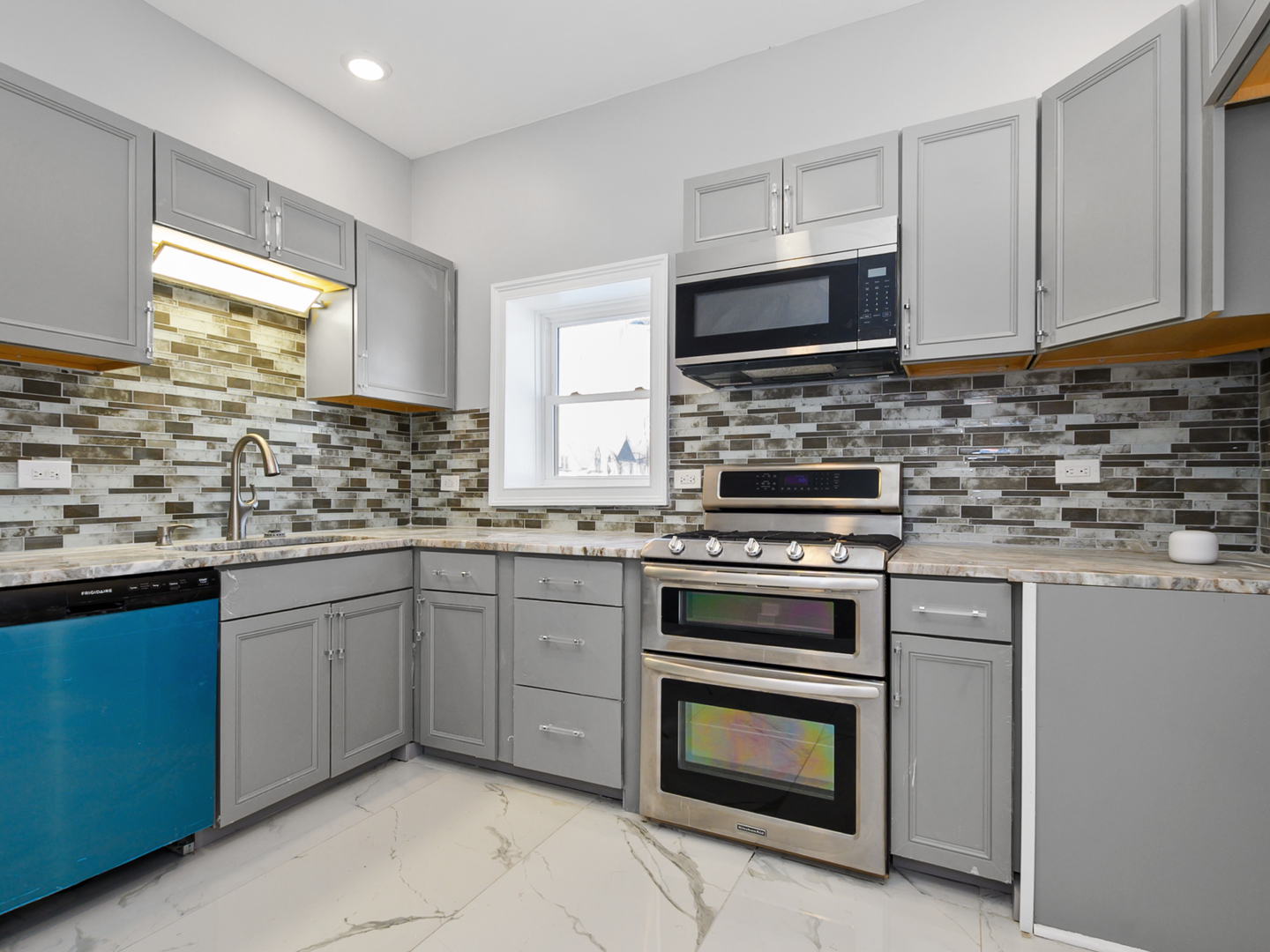 7305 South Sangamon Street Chicago, IL 60621 - Photo 11 of 29 a kitchen with cabinets stainless steel appliances and a sink