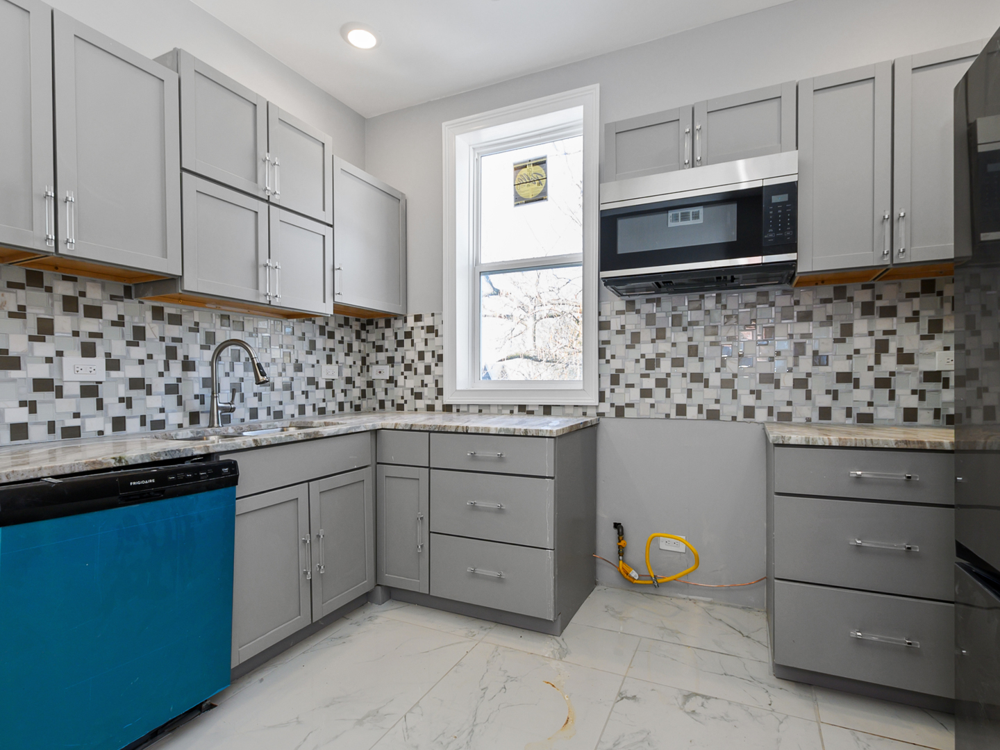 7305 South Sangamon Street Chicago, IL 60621 - Photo 15 of 29 a kitchen with granite countertop white cabinets and stainless steel appliances