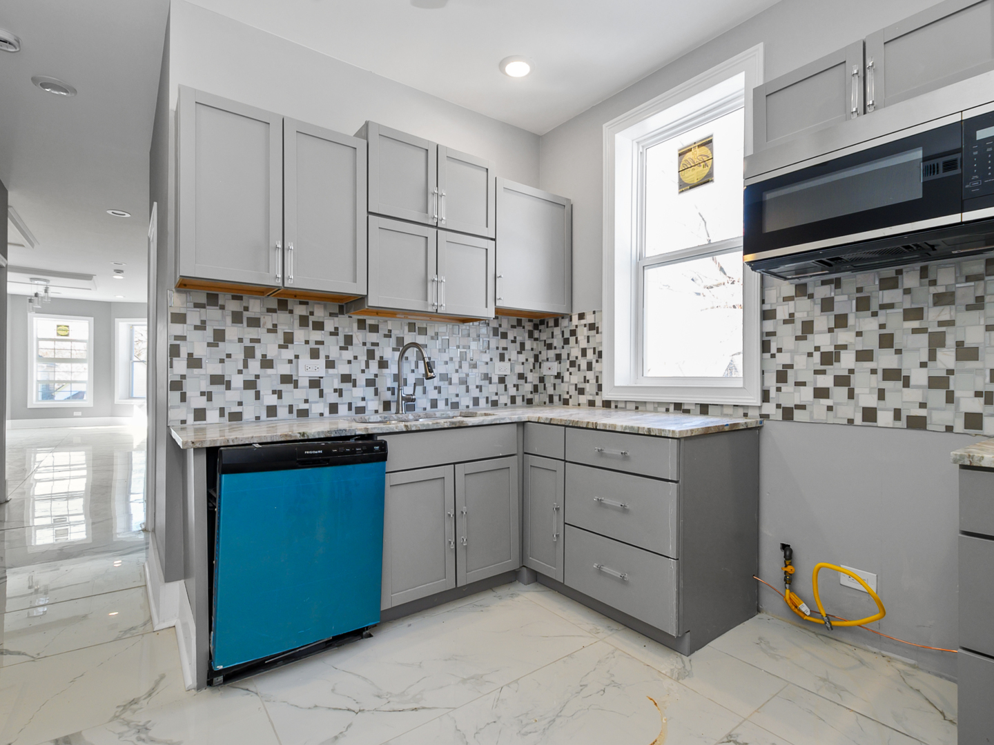 7305 South Sangamon Street Chicago, IL 60621 - Photo 16 of 29 a kitchen with a sink window and cabinets