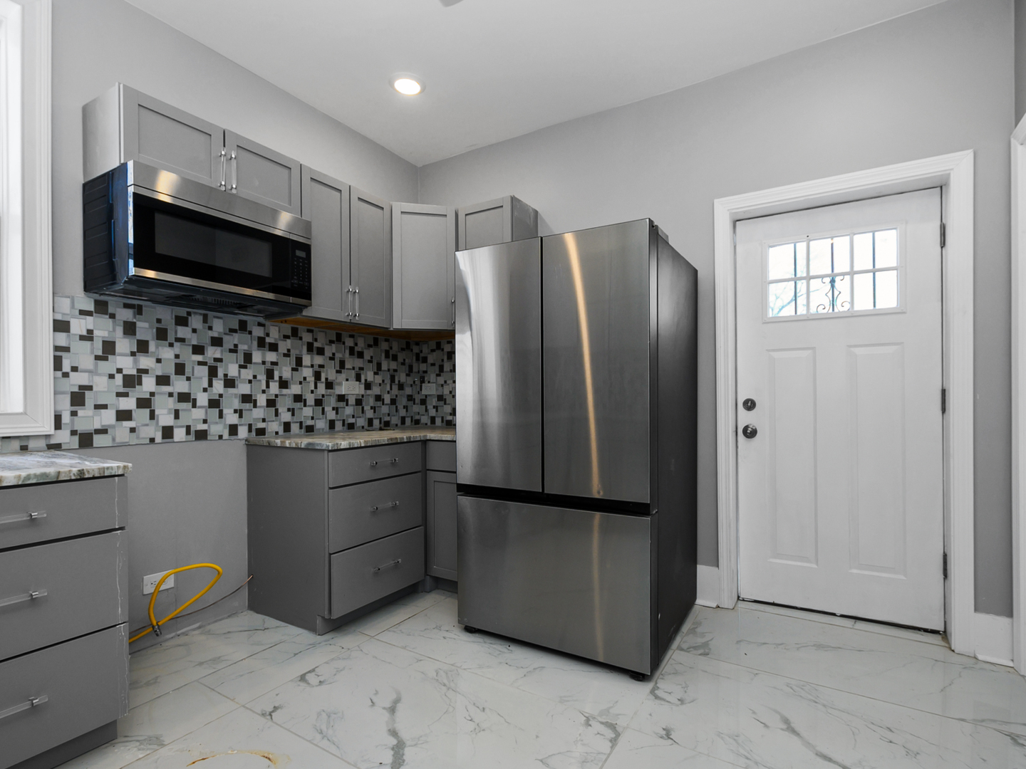 7305 South Sangamon Street Chicago, IL 60621 - Photo 18 of 29 a kitchen with stainless steel appliances granite countertop a refrigerator and a stove top oven