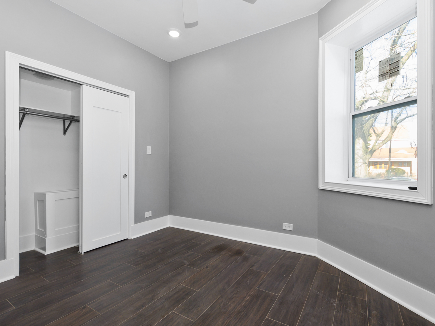 7305 South Sangamon Street Chicago, IL 60621 - Photo 21 of 29 a view of an empty room with wooden floor and a window