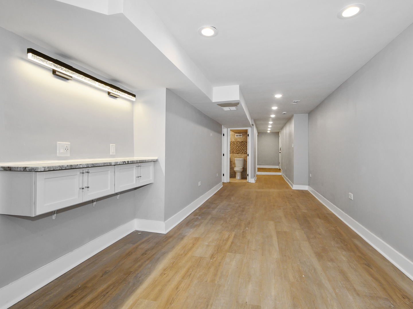 7305 South Sangamon Street Chicago, IL 60621 - Photo 26 of 29 a view of a big room with wooden floor and windows