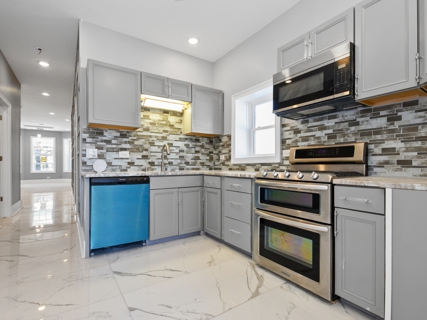 7305 South Sangamon Street Chicago, IL 60621 - Photo 3 of 29 a kitchen with stainless steel appliances granite countertop a stove microwave and cabinets