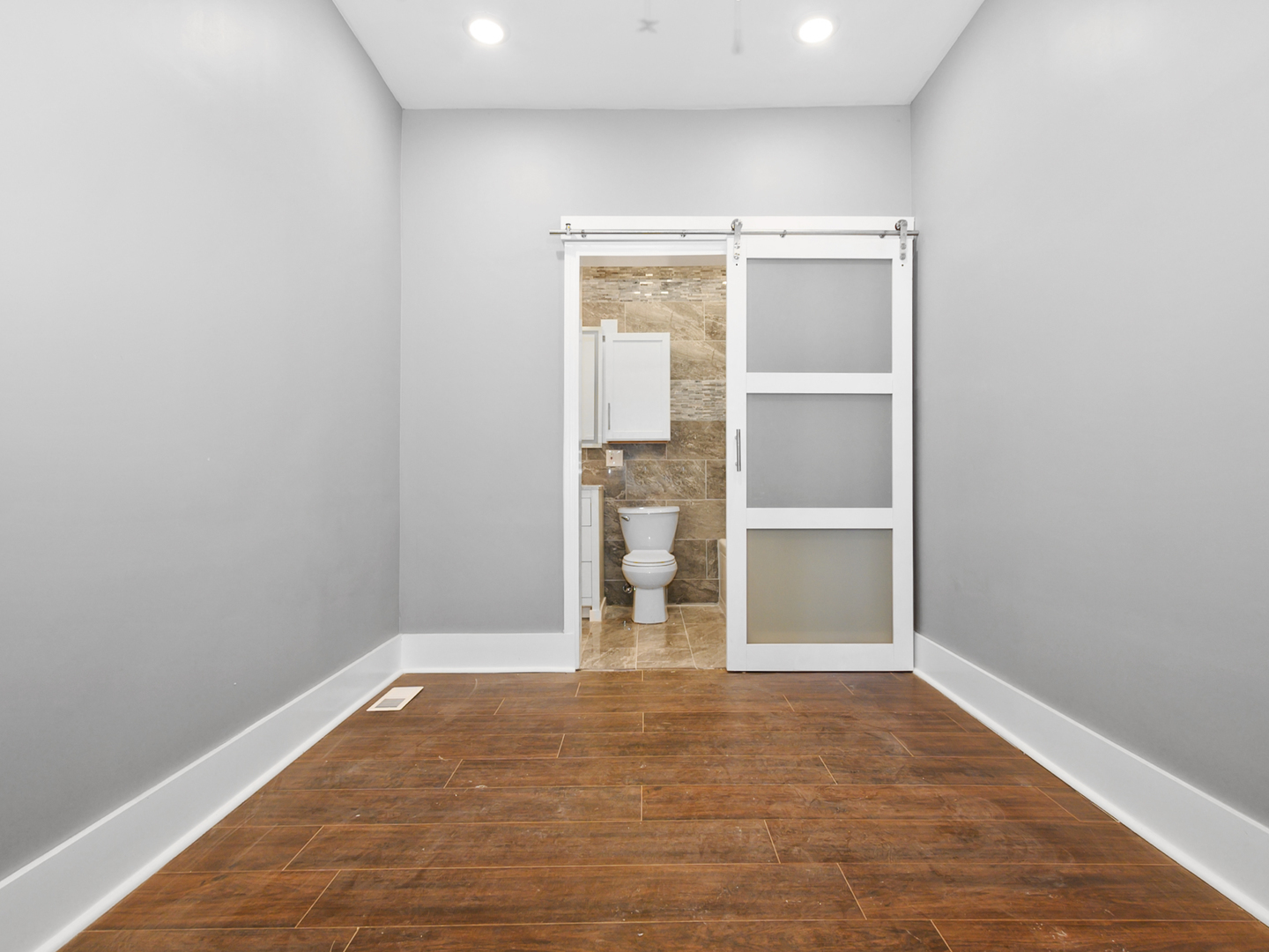 7305 South Sangamon Street Chicago, IL 60621 - Photo 7 of 29 a view of empty room with wooden floor
