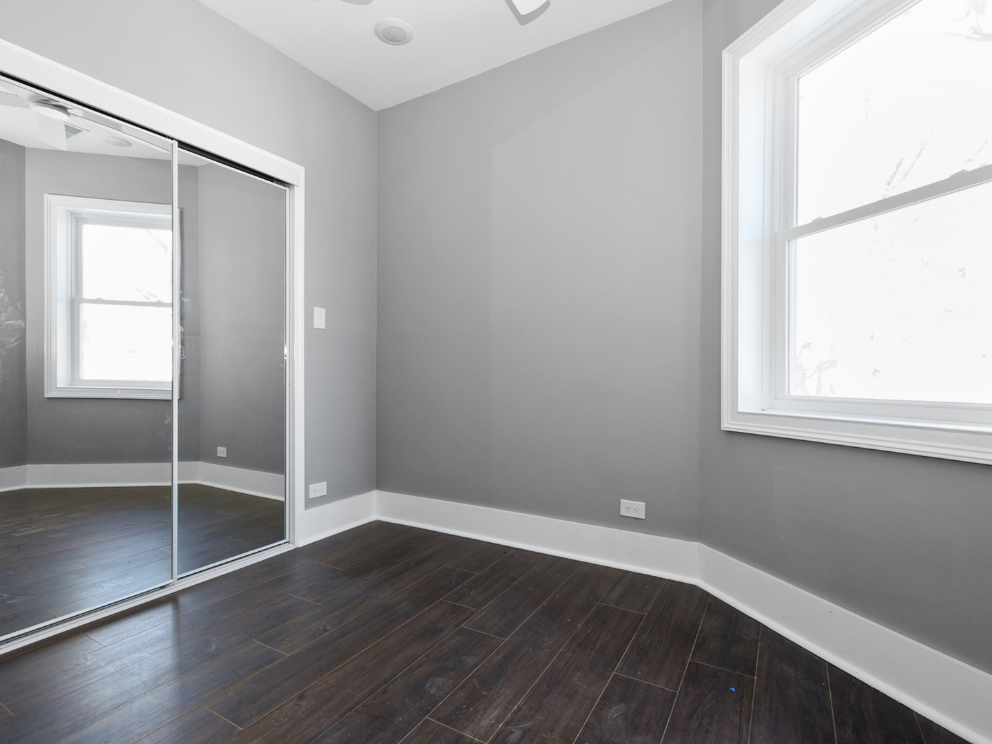 7305 South Sangamon Street Chicago, IL 60621 - Photo 8 of 29 an empty room with wooden floor and windows