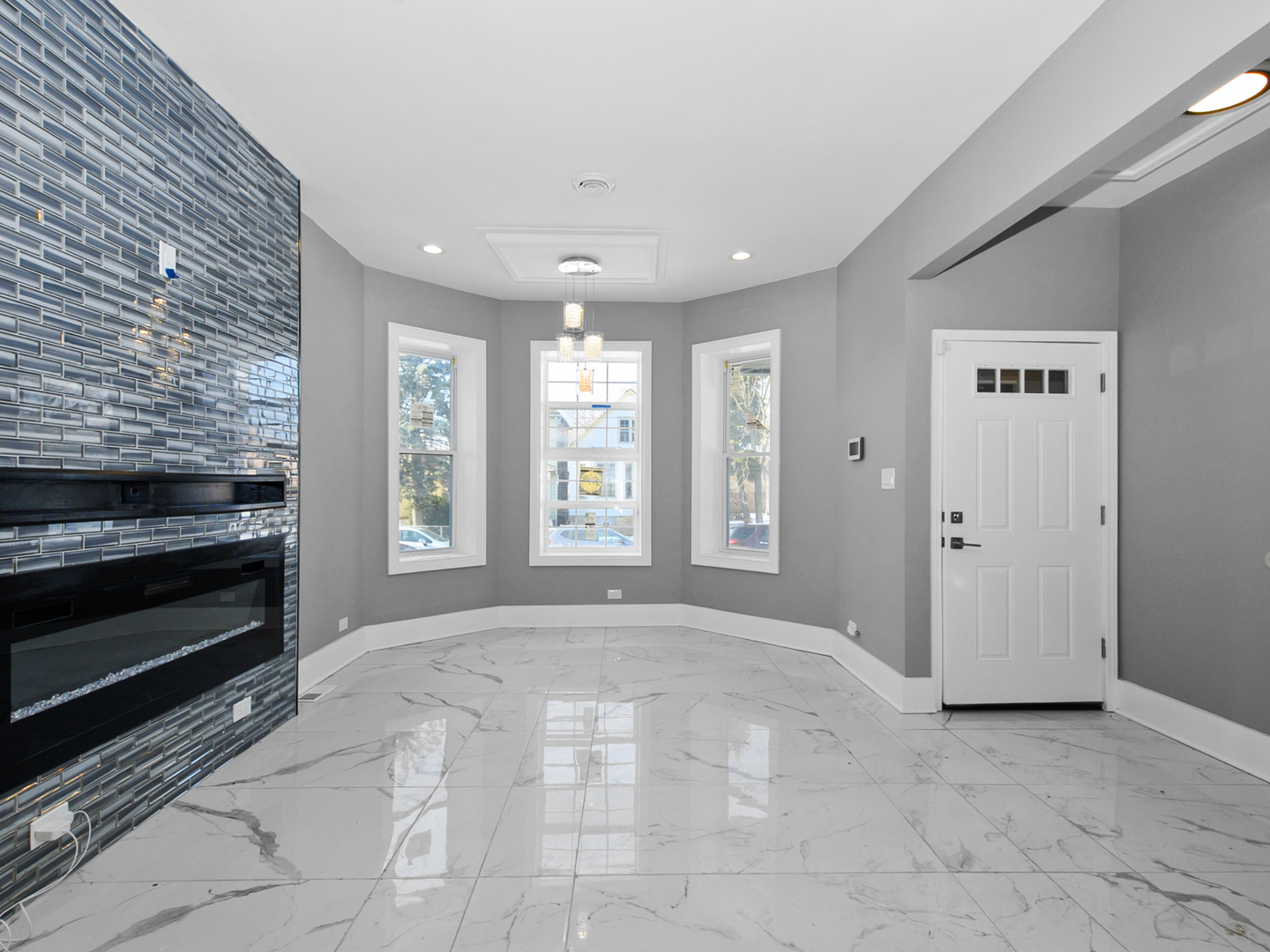 7305 South Sangamon Street Chicago, IL 60621 - Photo 9 of 29 a view of an empty room with a fireplace and a window