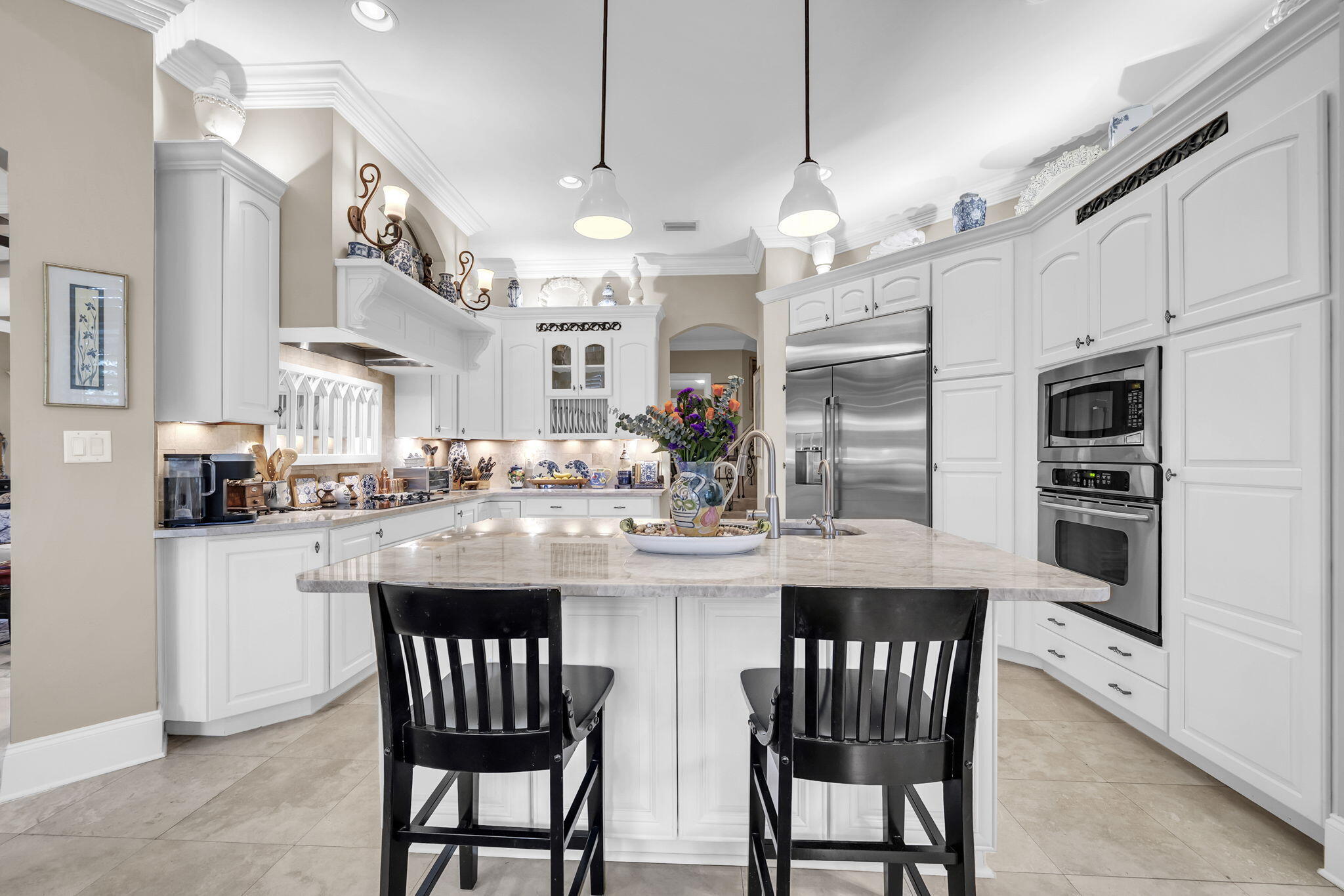 4470 Stonebridge Road Destin, FL 32541 - Photo 28 of 114 a kitchen with stainless steel appliances granite countertop a dining table chairs and white cabinets