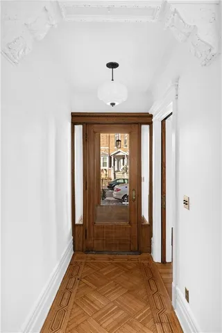 a view of a big room with a chandelier fan and windows